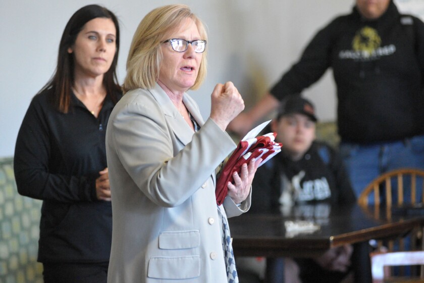 U.S. Representative Michelle Fischbach presenting flag at Kalon Prep