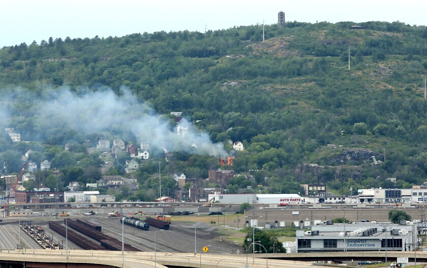 A fire can be seen from the Blatnik Bridge burning in Duluth at West 1st Street and Piedmont Avenue