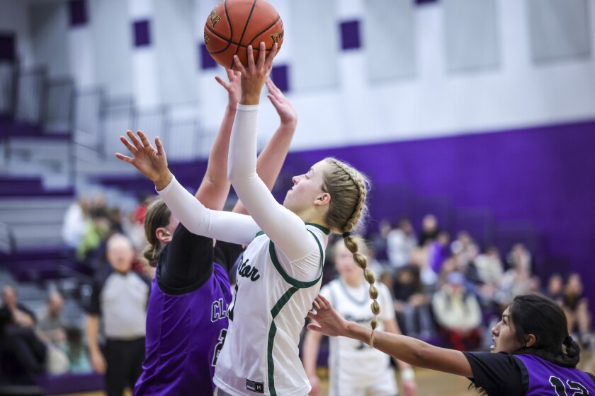 high school girls play basketball