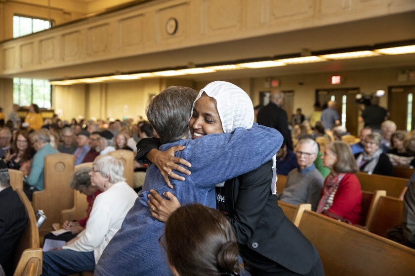 Ilhan Omarh hugs Ann Gilbert