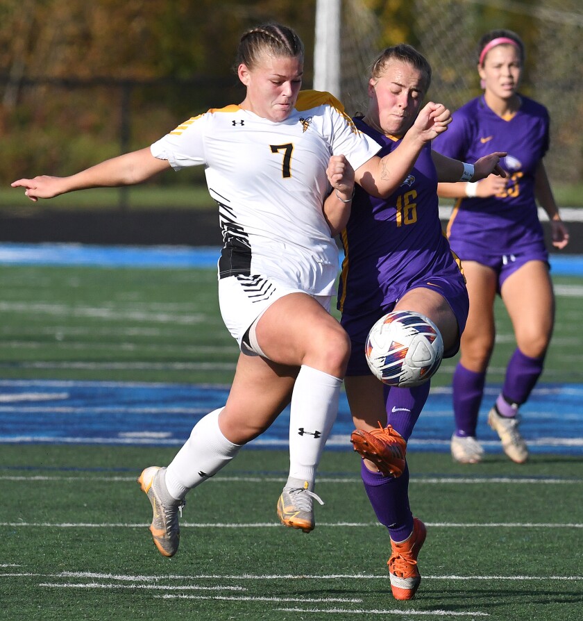 UW-Superior’s Mya Holmquist (7) runs through Northwestern’s Miciah Renn (16) as she moves the ball up the field