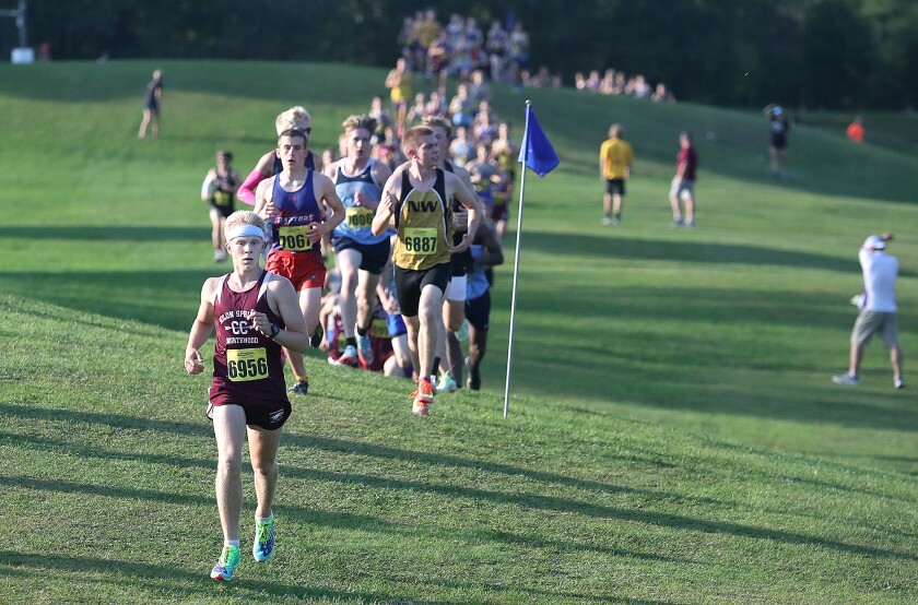 Solon Springs’ Dylan Taggart (6956) leads the pack in the first lap at the John Woodbury Invitational