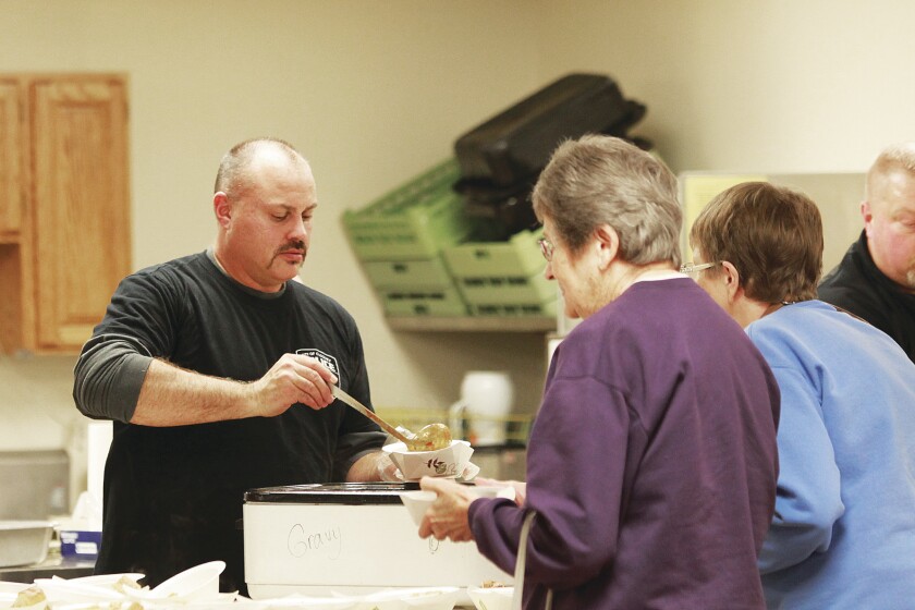 Sgt. Rick Benko serves a helping of chili to guests during Santa's Home for the Holidays on Wednesday, Nov. 28. They served about 300 pounds of chili. This was the second year of the chili feed, organized by the Cloquet and Fond du Lac police departments. Jamie Lund/Pine Journal