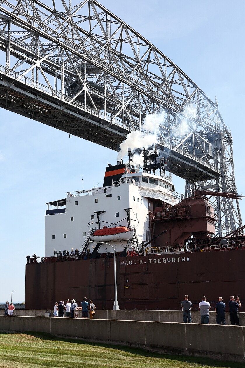 Ship moves under bridge.