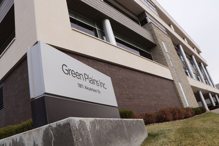 A sign says "Green Plains, Inc." flanked by an office building.