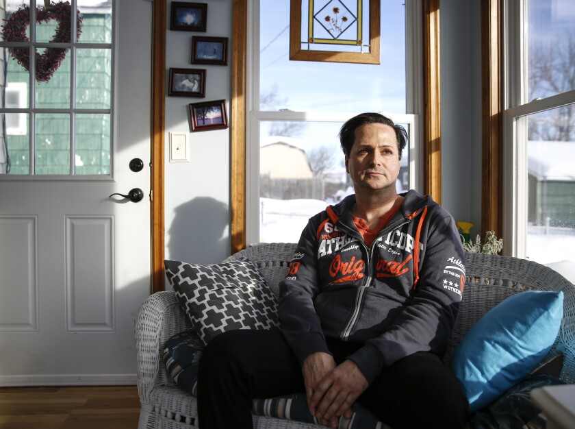 Travis Paulson poses for a portrait in his mother's sunroom on Feb. 13. Paulson used to own sports cars and live on his own. When insulin prices became too much to handle, he gave up his home, car and way of life. He used to go days without eating to ration insulin. Tyler Schank / tschank@duluthnews.com