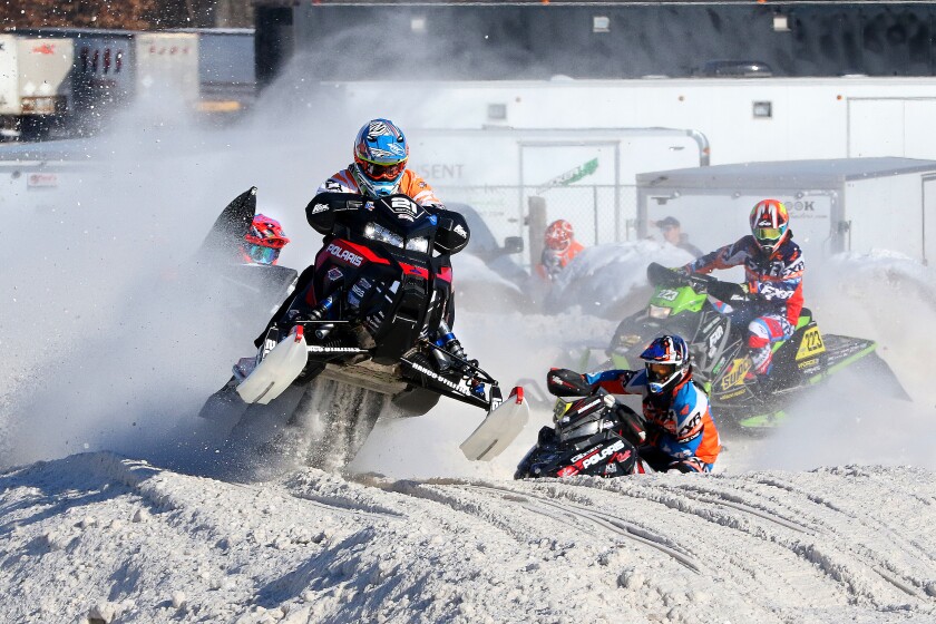 Snowmobilers race around the track Saturday during the Amsoil Championship Minnesota Regional SnoCross at the Crow Wing County Fairgrounds. Kelly Humphrey / Brainerd Dispatch - Gallery and Video