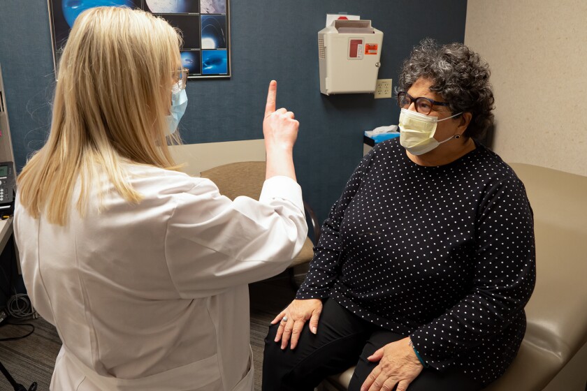 Terri Barta watches Dr. Tonya Harlow move a finger in front of her