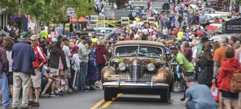 A 1941 Cadillac pulls through the crowd in Fairport, NY.jpg