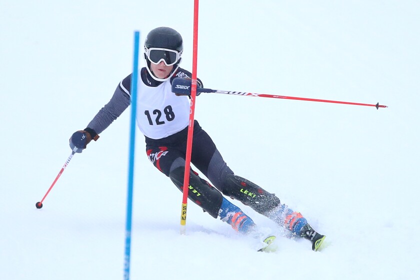 Duluth East’s William Quincy Smith (128) gets around a gate during his run