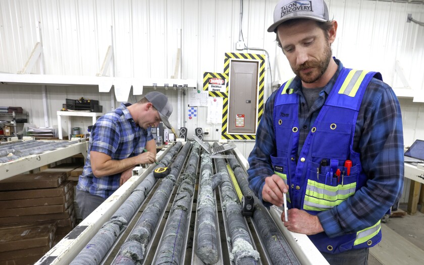 Geologists examine core samples.