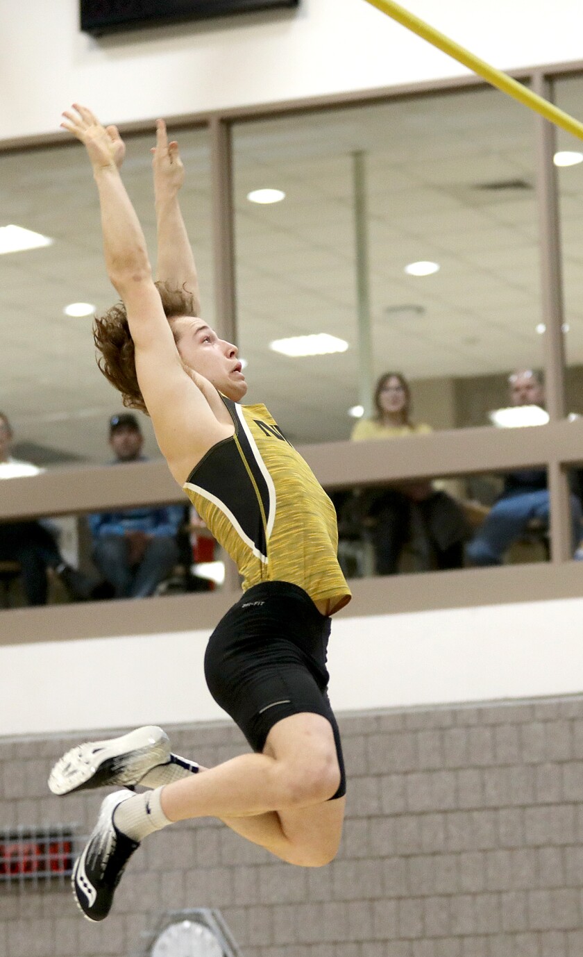 Northwestern’s Cam Benesch watches the bar stay put while he falls to the mat