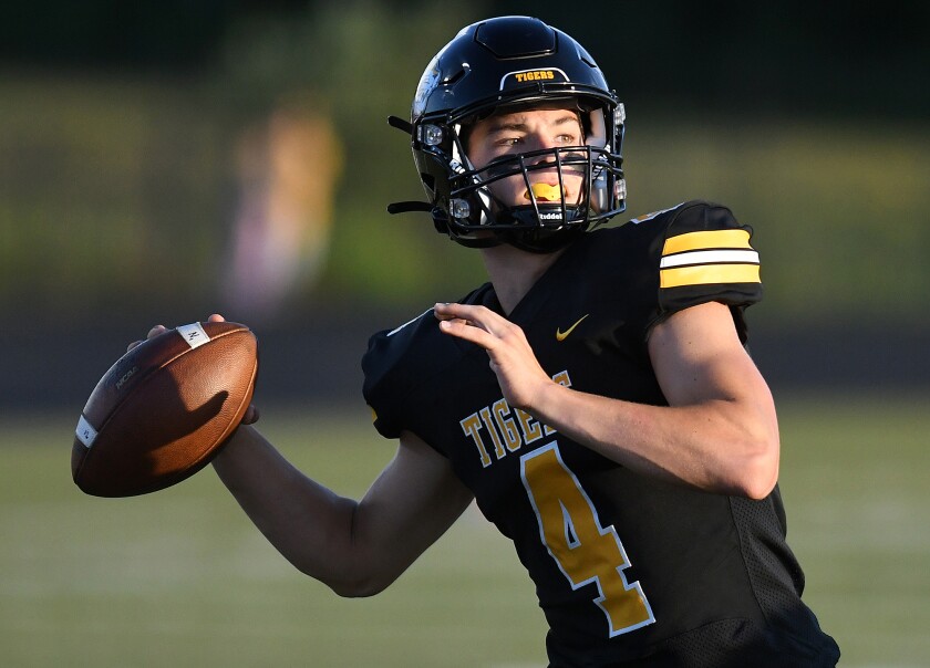 Northwestern quarterback Luke Sedin (4) looks downfield before throwing a first quarter touchdown