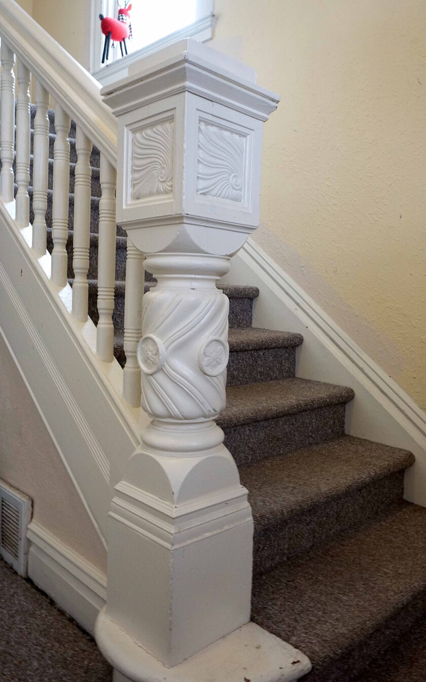 A stairwell bannister inside of a historic home in Duluth