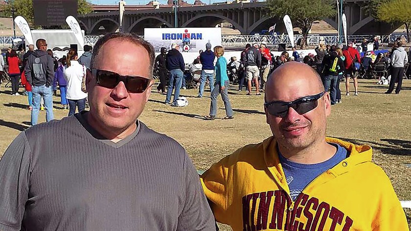 Gary Walters (left) and Josh Heldt pause at the Ironman Village on on Nov. 17, 2014, the day after they fell short of their goal to complete the triathlon in Tempe, Ariz. They signed up for the Ironman 2015 on the spot and both completed the event Sunday. Submitted photo video