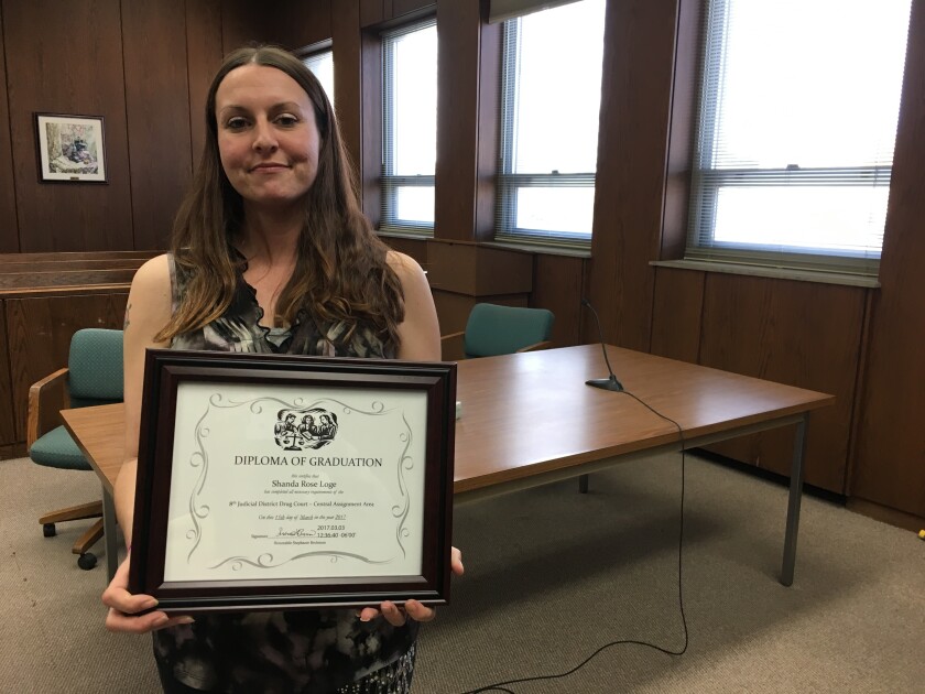 Shanda Loge shows her graduation certificate from Eighth District Drug Court. She graduated Wednesday from the program.