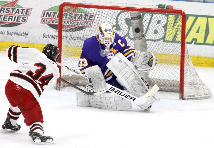 Cloquet-Esko-Carlton goalie Jacob Walsh (33) deflects a breakaway shot by Duluth East’s Noah Teng (34)