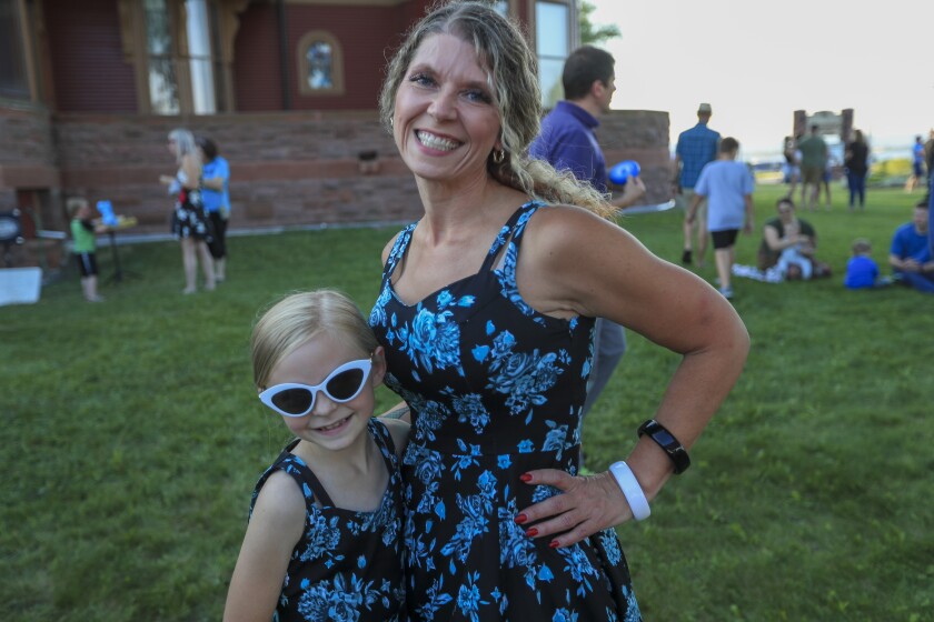 People outdoors at historic mansion