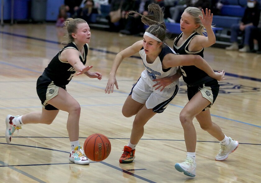 Superior’s Savannah Leopold (20) gets fouled as she splits the Hayward defense of Madi Bergschnieder (13) and Greta Schmitt (5)