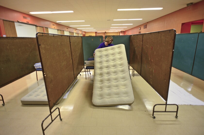 In this Forum file photo from 2015, Jeanne Rodriguez moves an air mattress into place in preparation for the F-M Sheltering Churches project. At the Fargo City Commission meeting on Monday, May 8, advocates announced the project is commencing after six years of area churches serving as overflow shelters. Rick Abbott / The Forum