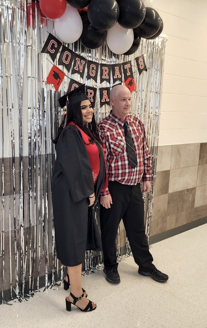 A graduate poses for a picture prior to the ceremony at the Learning Center on Thursday, May 26, 2022.