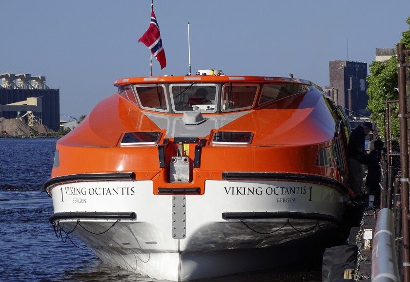 Passengers debark a tender.