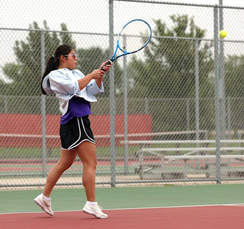 Worthington Trojans Taya Oberloh returns a volley during tennis practice Monday morning.