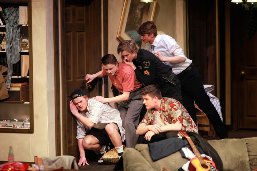 (L-R) Oscar Madison (Seth Brandl), Vinnie (Ben Johnson), Murray (Ryan Soleim), Speed (Drew Relling) and Roy (Floyd Althoff) listen to make sure Felix Ungar is OK in the first act of the Red River High School's production of "The Odd Couple." Photo by Eric Hylden/Grand Forks Herald