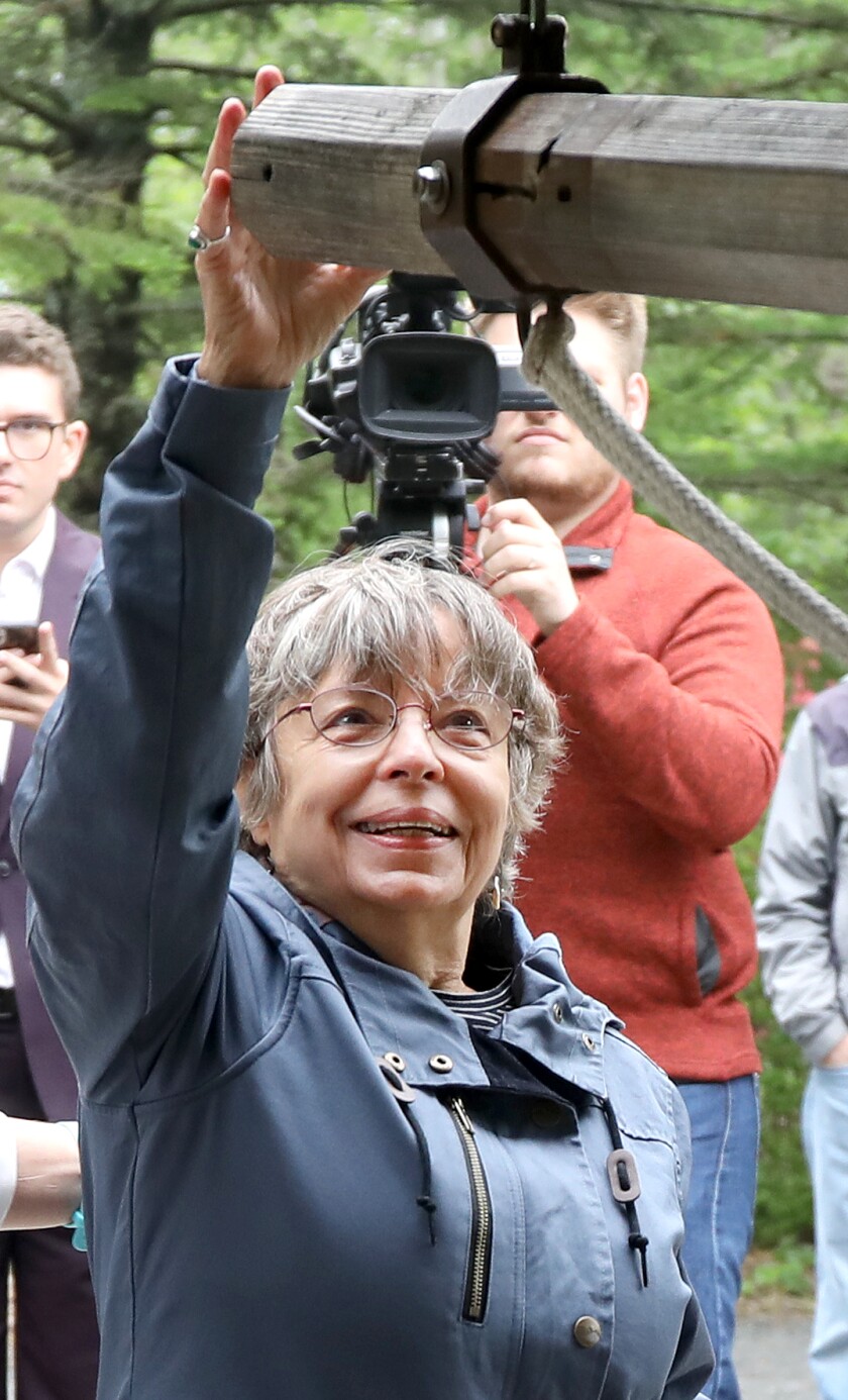 Barbara Auerbach, daughter of former Duluth Mayor George D. Johnson, gets ready to ring the Peace Bell replica
