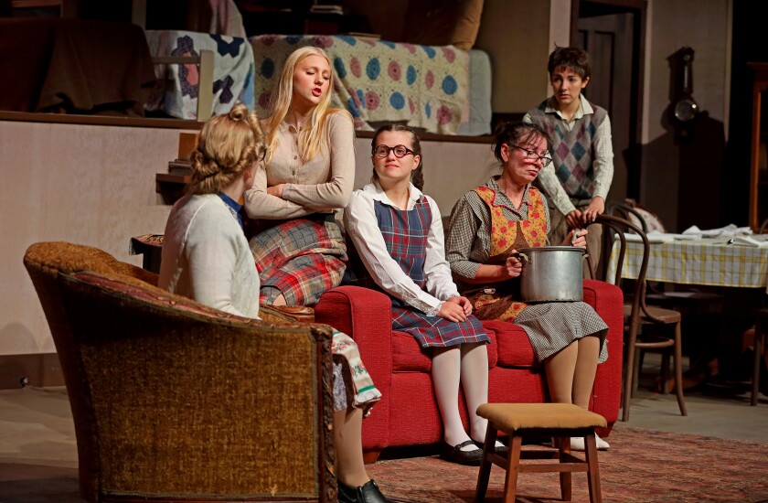 Actors rehearse on stage.