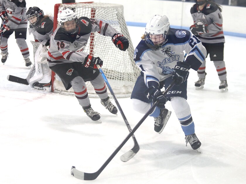 Superior’s Autumn Cooper (21) keeps the puck away from Chippewa Falls/ Menomonie’s Rhylee Buesgen (26)