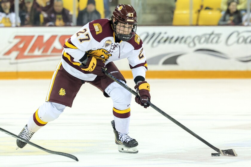 college men play ice hockey