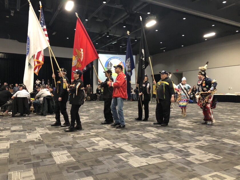 Members of the Fond du Lac Band of Lake Superior Chippewa Honor Guard, including FDL Chairman Kevin Dupuis (in red), start the ceremonies Monday, Jan. 29, followed by adult dancers Herb Fineday and Emily Smith and youth royalty dancers. More than 100 members of the Band gathered to celebrate the resolution of a legal case protecting the rights of FDL members to hunt, fish and gather on lands ceded as part of the 1854 Treaty. Jana Peterson/jpeterson@pinejournal.com