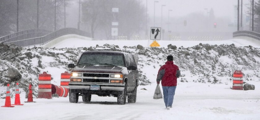 Fargo police officers push out a stuck vehicle