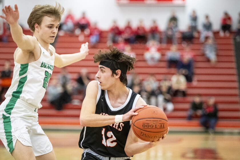Litchfield sophomore Blake Aller guards Morris Area/Chokio-Alberta senior Brandon Jergenson during a Section 3AA-North semifinal boys basketball game at Willmar High School on Thursday, March 10, 2022.