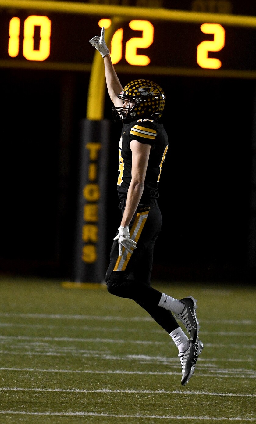 Northwestern’s Jase Nelson (19) celebrates recovering an Aquinas fumble