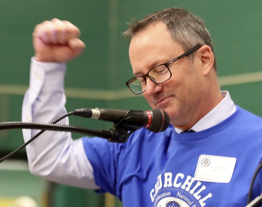 Speaker pumps a fist in the air.