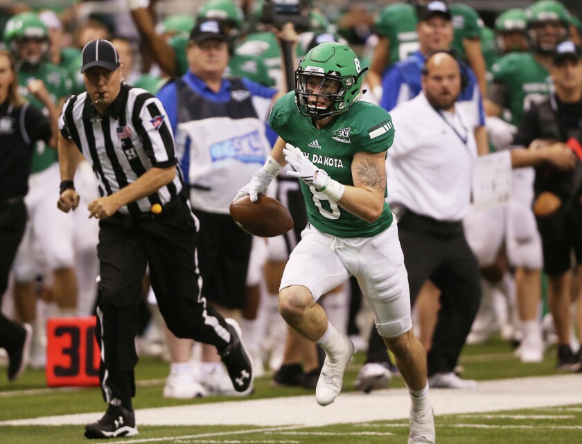 Junior Cole Reyes (8) runs unopposed after an interception for a University of North Daktoa touchdown in the first half of Saturday's Potato Bowl against the University of South Daktoa at the Alerus Center in Grand Forks, N.D. (Jesse Trelstad/Grand Forks Herald)