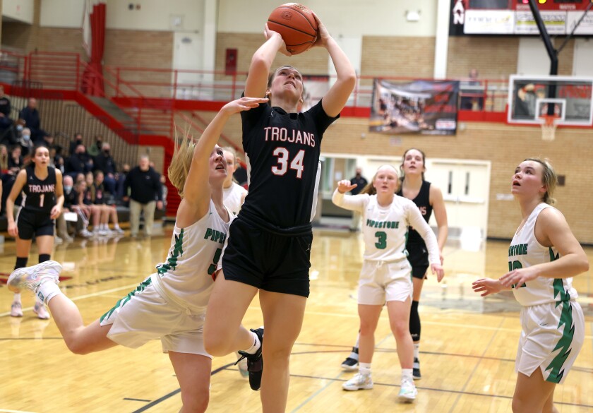 Worthington Trojans Ellie Weg (34) takes a pass to the Basket past Pipestone Defenders Aubrea Kor (5), Marli Taubert (3) and Kyla Hubbling (12) for two points.