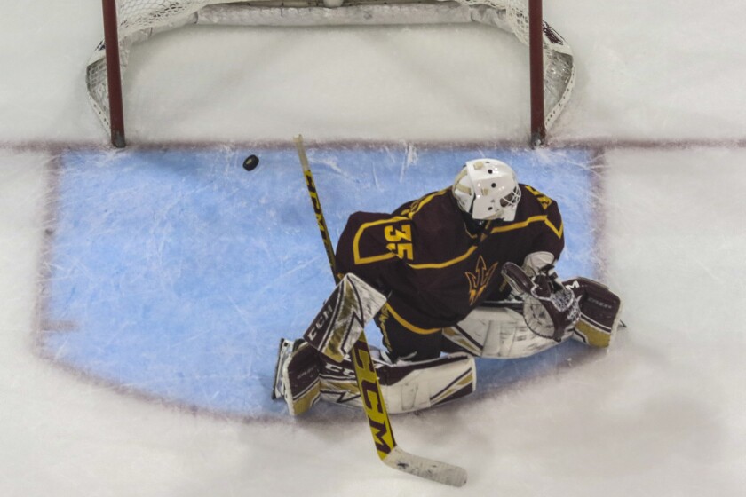 College hockey game in an indoor arena