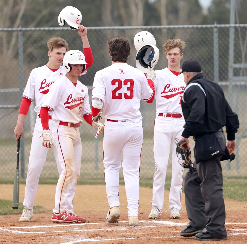 042822 N DLuverne Cardinals salute pitcher Conner Connell (23) with their batting helmets after his hit over the fence brings in three runs during a game with the Trojans in Worthington.G Worthington Baseball vs Luverne S1.jpg