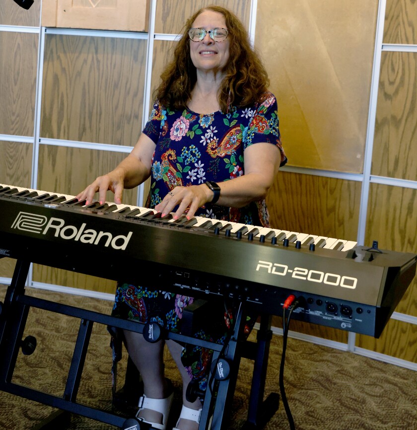 Tammy Makram, managing director of the Memorial Auditorium Performing Arts Center, tries out the new Roland Keyboard.
