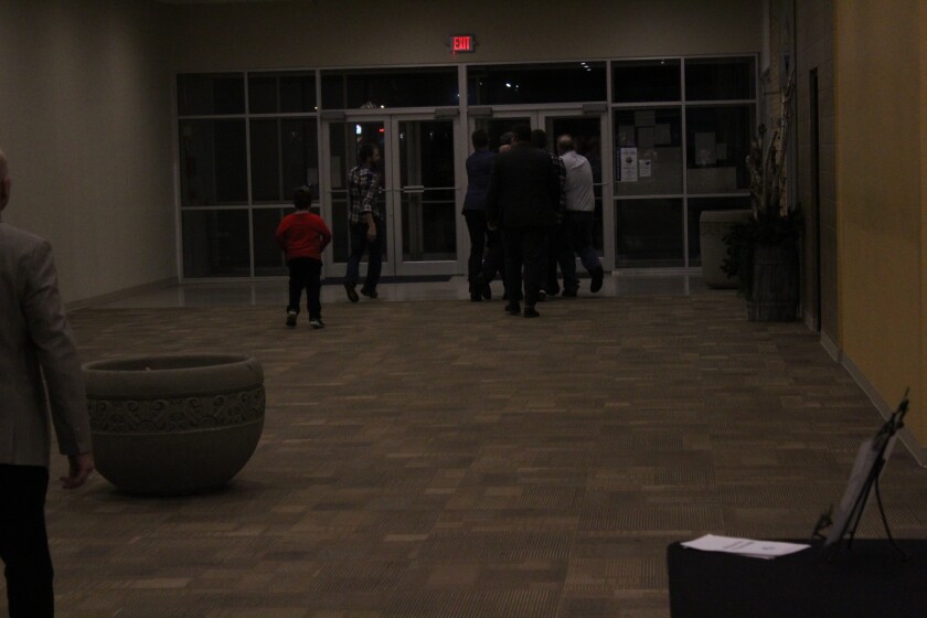 The two men were escorted from the building by several members of Dickinson's River Church. (Grady McGregor / The Dickinson Service)
