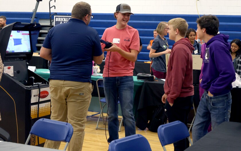 Students from Murray County Central try their hands at a virtual commercial spray painting interactive display at the Career Expo at Minnesota West Community and Technical College Tuesday, Oct. 4, 2022.
