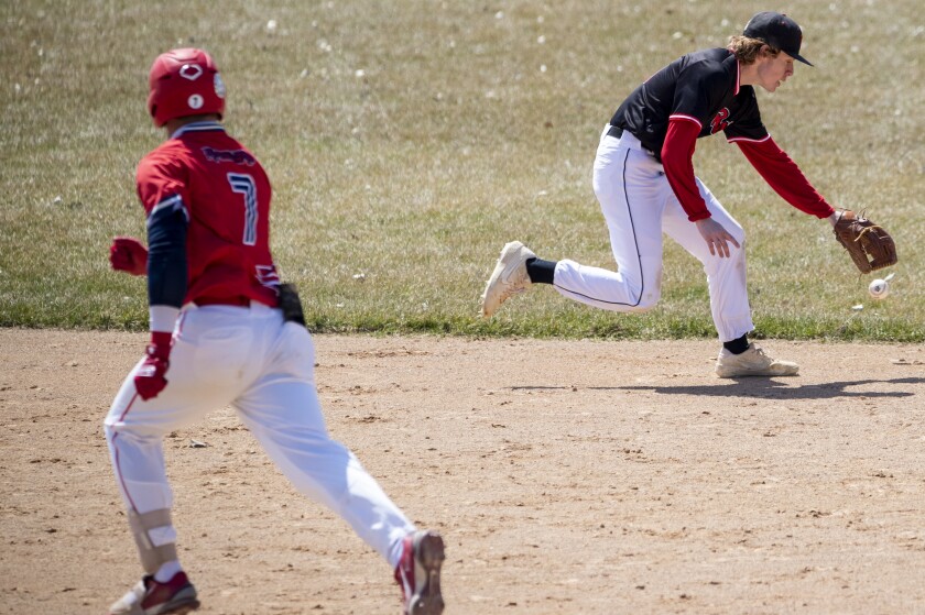 Ridgewater shortstop Colin Ochoa chases down a loose ball while Eli Roberts of Central Lakes College runs toward third base during a game at Green Lake Baseball Diamonds in Spicer on Wednesday, April 27, 2022.