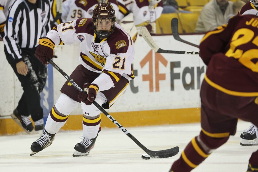 College hockey players play game in indoor arena