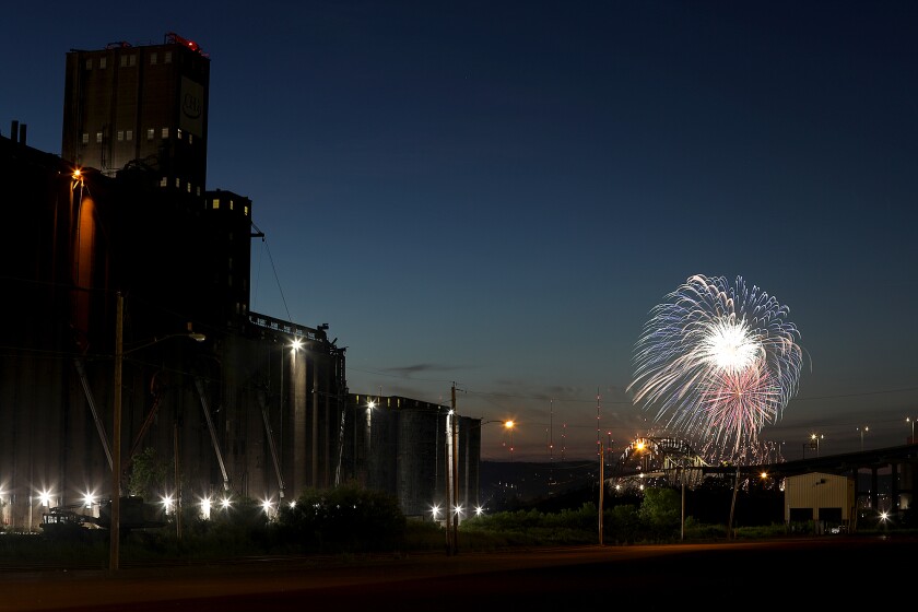Fireworks from Duluth’s Fourth Fest explode over the Blatnik Bridge