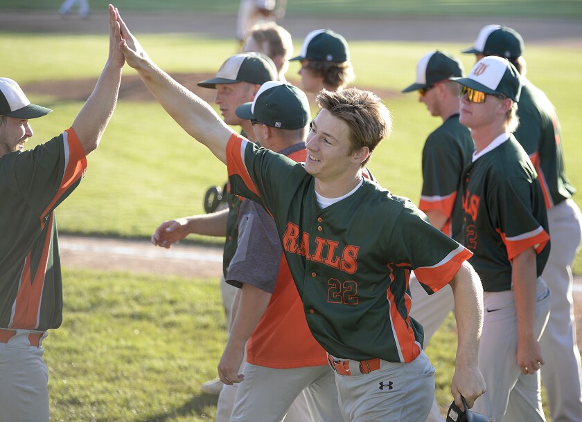 The Willmar Rails' Ashton Gregory, 22, celebrates at home with his teammates after hitting a three-run home run in the 13th inning to put Willmar up for good during a Region 4C elimination game against the Paynesville Pirates on Monday, Aug. 8, 2022 at Green Lake Diamonds in Spicer.