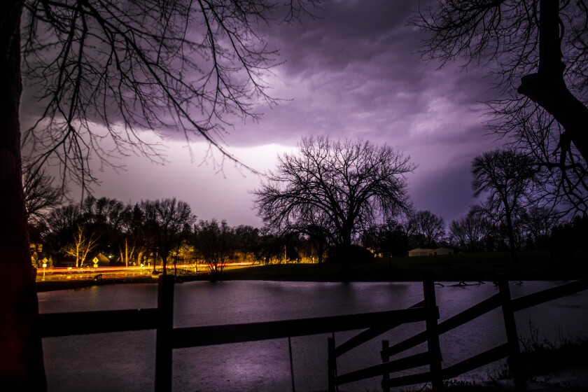 Lightning strikes illuminate the sky over the Middle Fork Crow River near Spicer the evening of Thursday, May 12, 2022. The storm brought down trees and infrastructure, causing multi-hour power outages in the area.