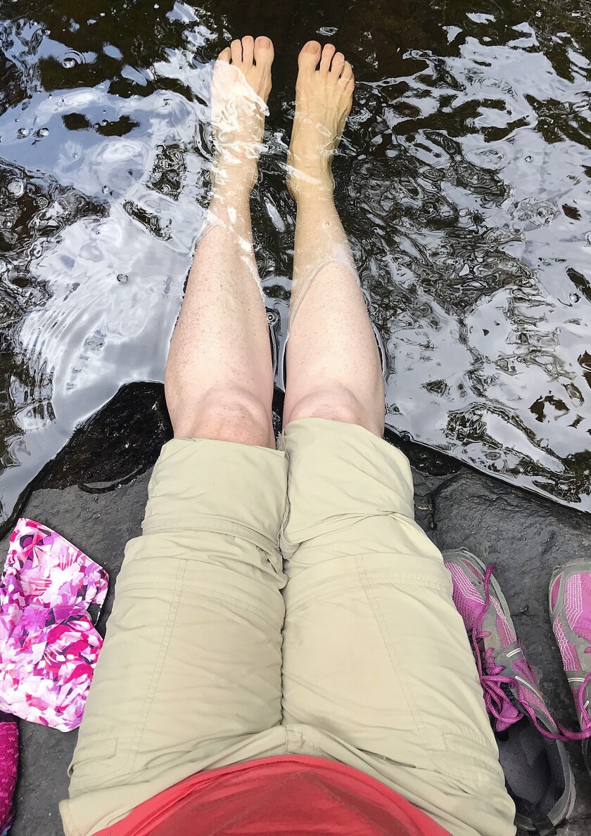 Jen Theisen soaks her legs during a recent hike on the Superior Hiking Trail. Dipping them in cold water seems to help her hiker’s rash. Medical authorities believe hiker’s rash occurs when temperature regulation mechanisms within leg muscles break down, leading to reduced blood flow. Photo courtesy of Jen Theisen